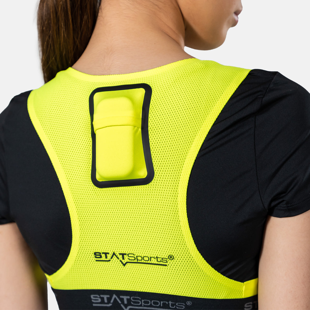 Yellow STATSports GPS vest worn by a woman, rear three-quarter view